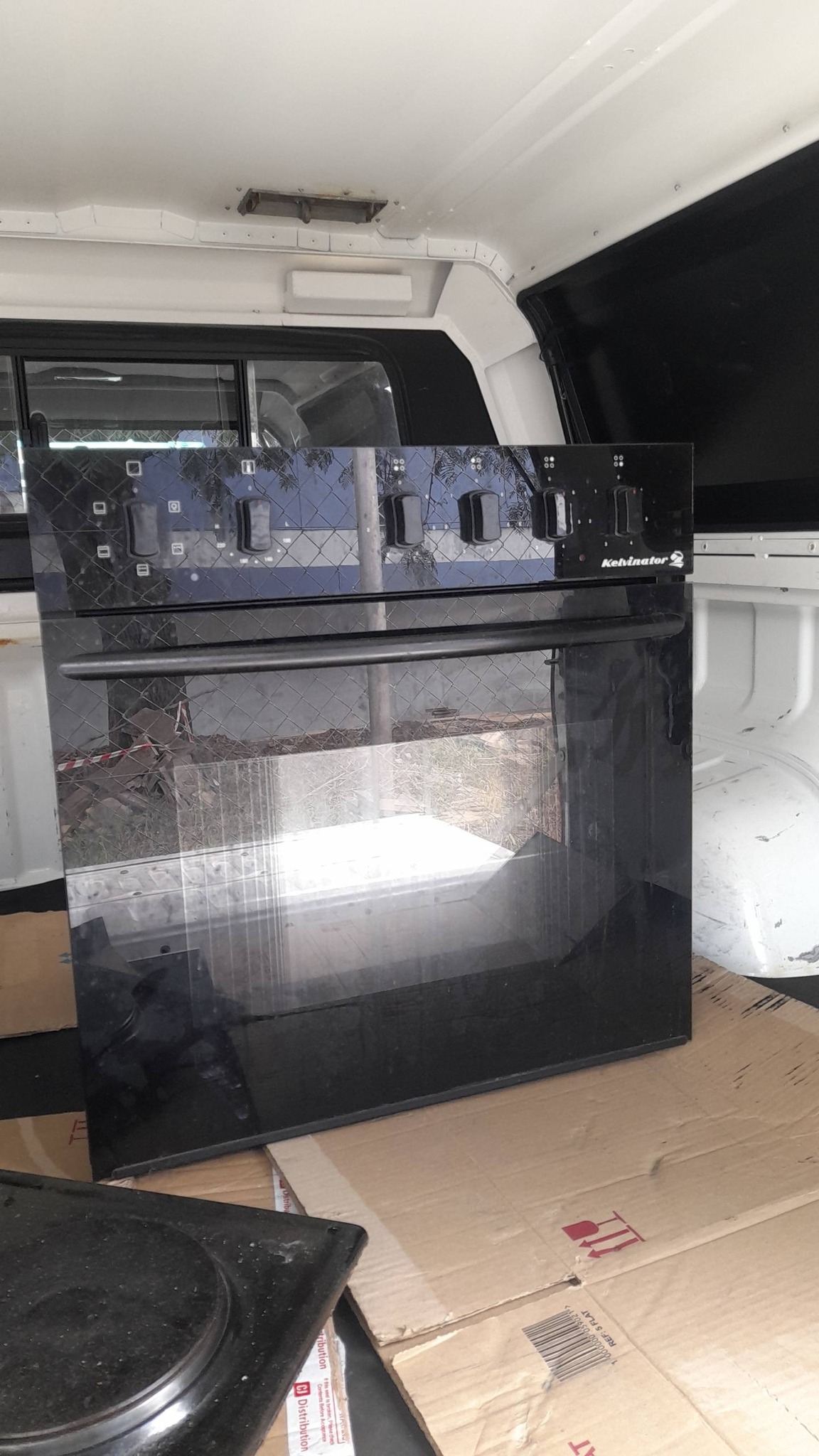 Technician repairing oven in Santa Cruz CA fixing heating problem and damaged components