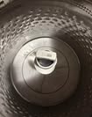 Close-up view of a washing machine lid, showcasing the interior that may require repair or maintenance.